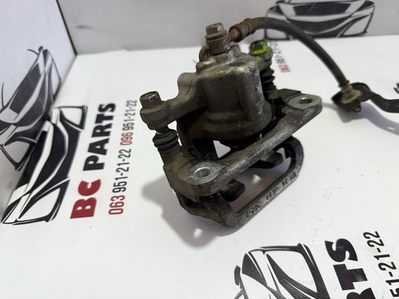 Суппорт тормозной задний левый Rogue 2013-2020 T32