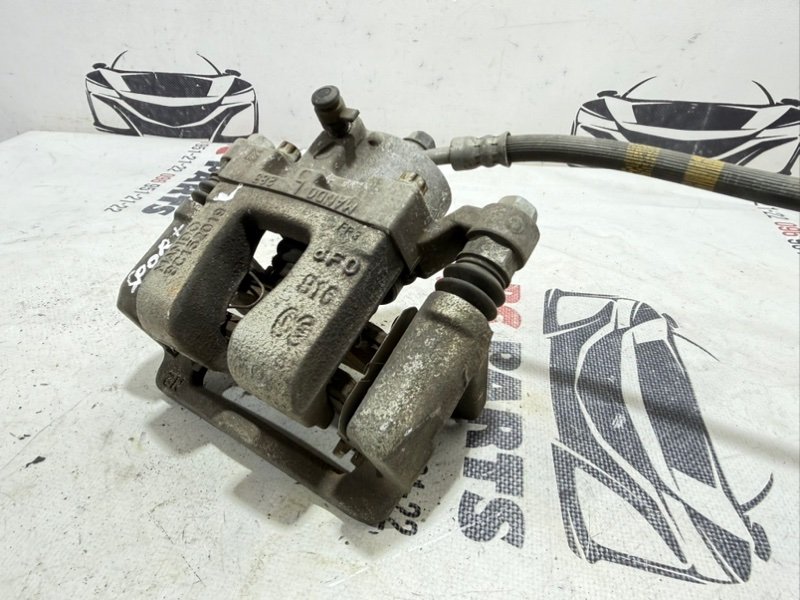 Суппорт тормозной задний левый Kia Sportage